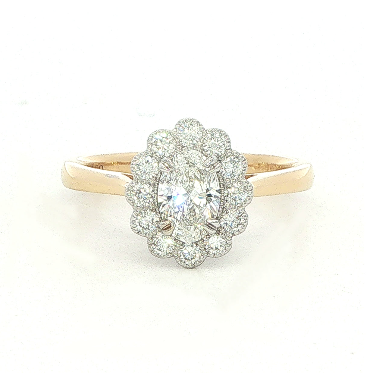 An 18 Carat Yellow and White Gold Oval Diamond Ring