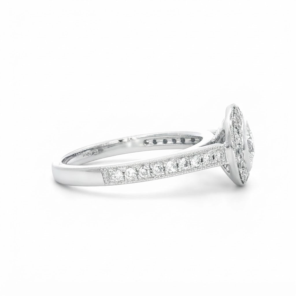 A Platinum and Diamond Vintage Style Halo Ring - 0.34 F VS2