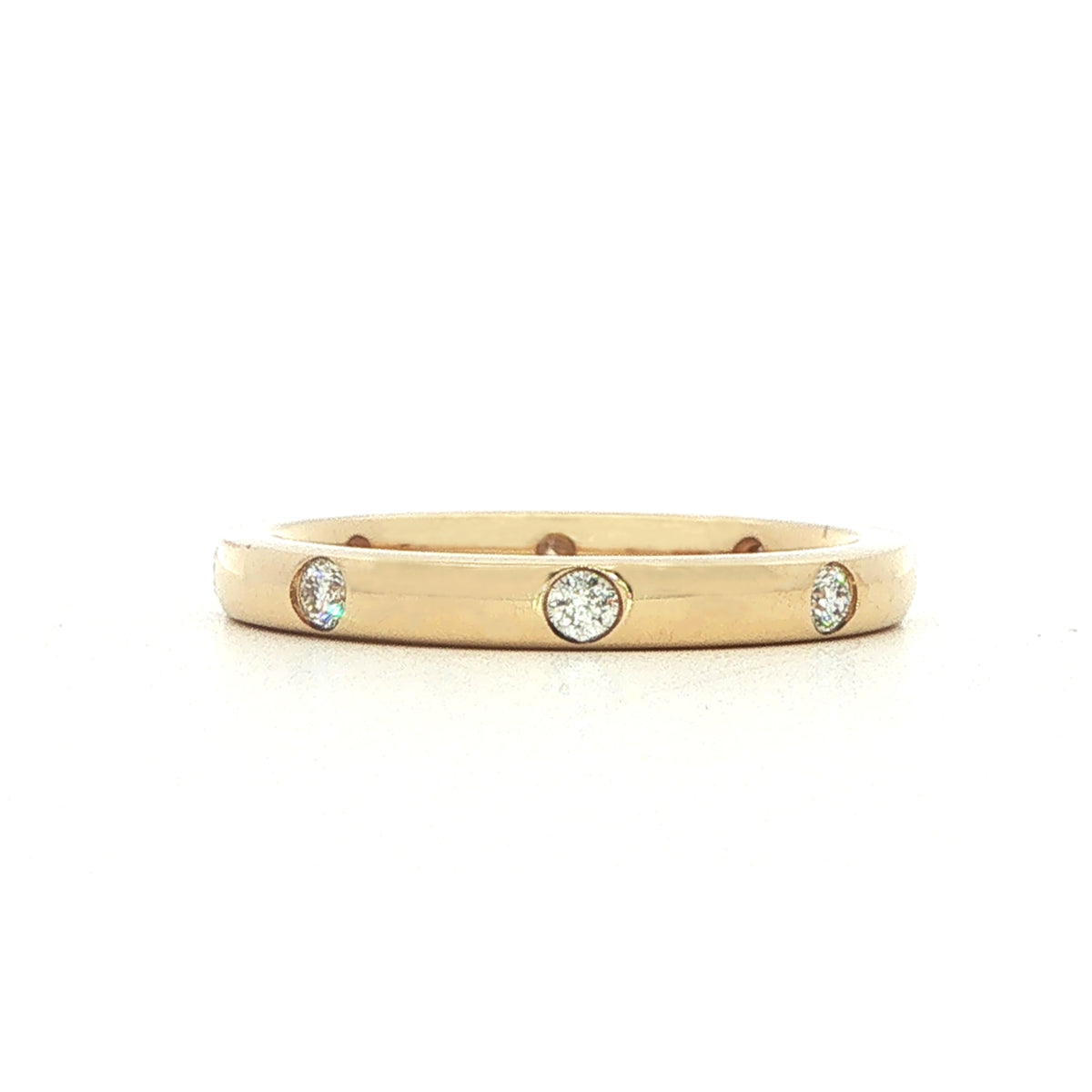 A 18 Carat Yellow and Diamond Flush Set Eternity Style Band