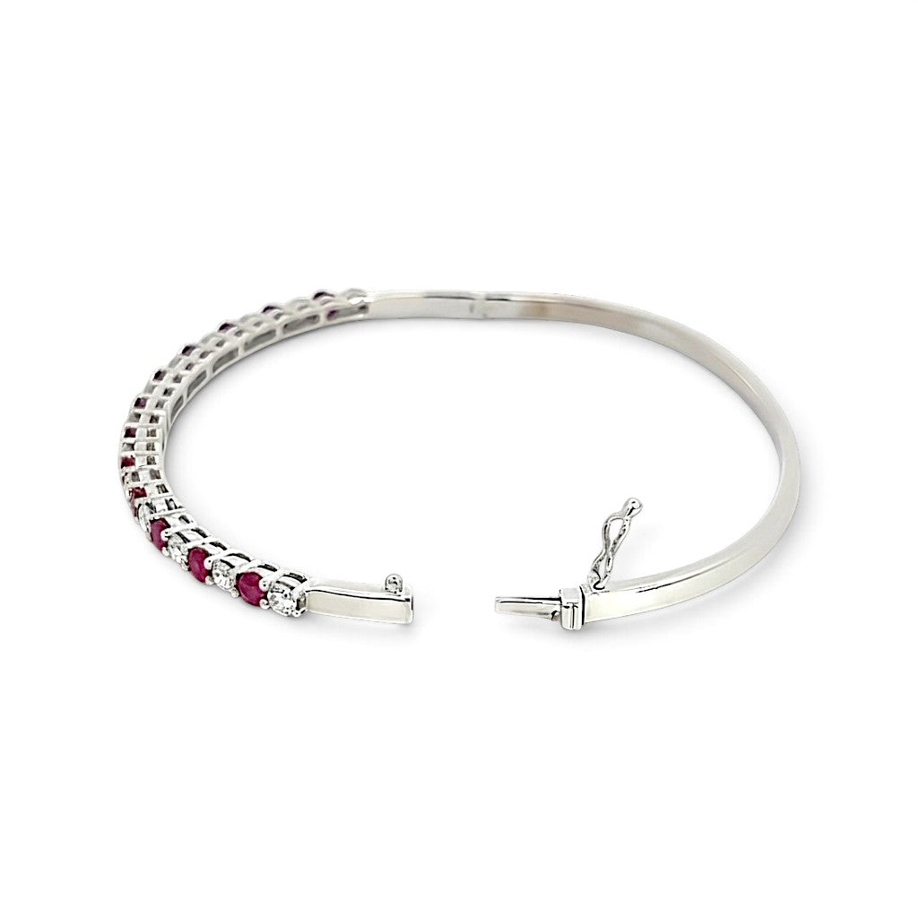 An 18 Carat White Gold Ruby and Diamond Hinge Bangle