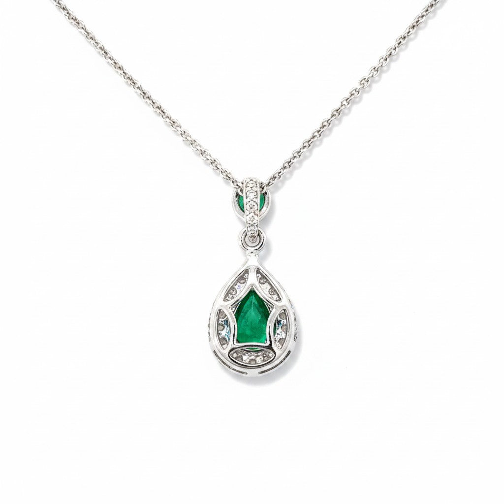 An 18 Carat White Gold Emerald and Diamond Halo Pendant