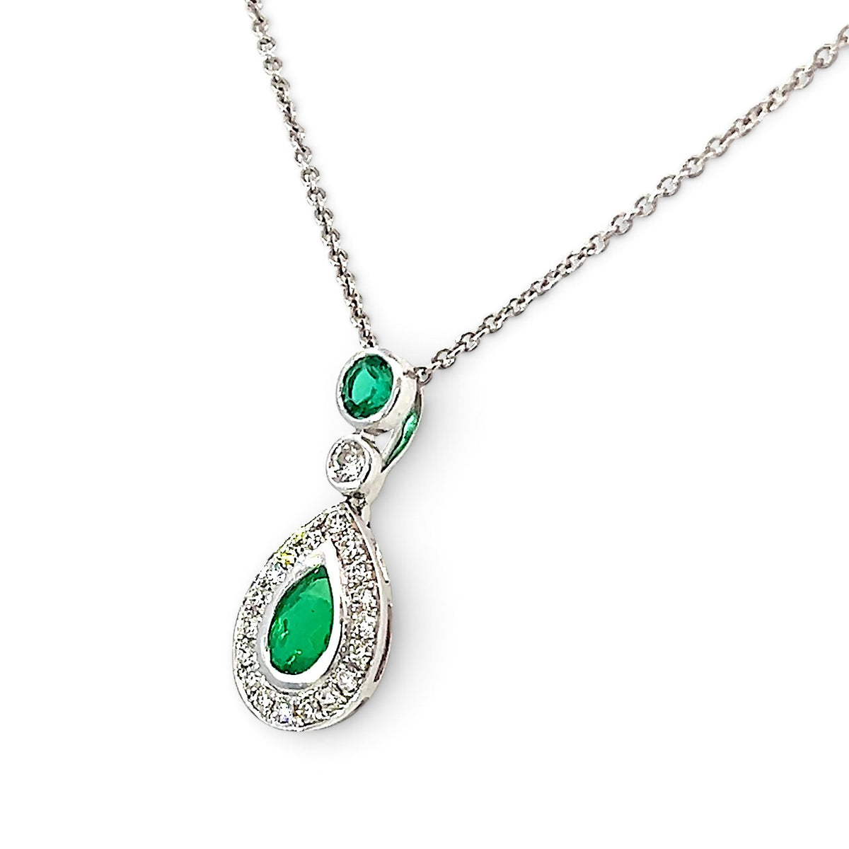 An 18 Carat White Gold Emerald and Diamond Halo Pendant