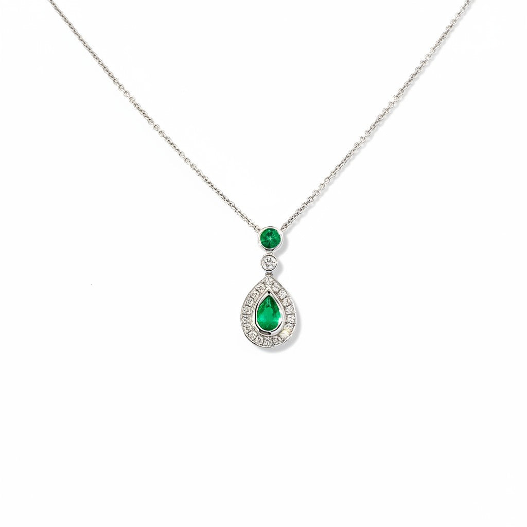 An 18 Carat White Gold Emerald and Diamond Halo Pendant