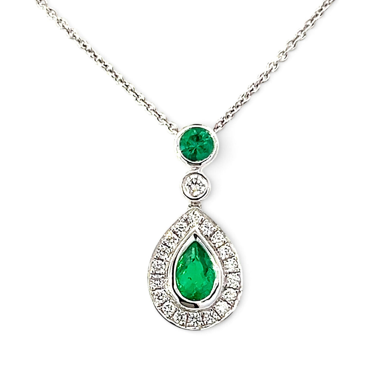An 18 Carat White Gold Emerald and Diamond Halo Pendant