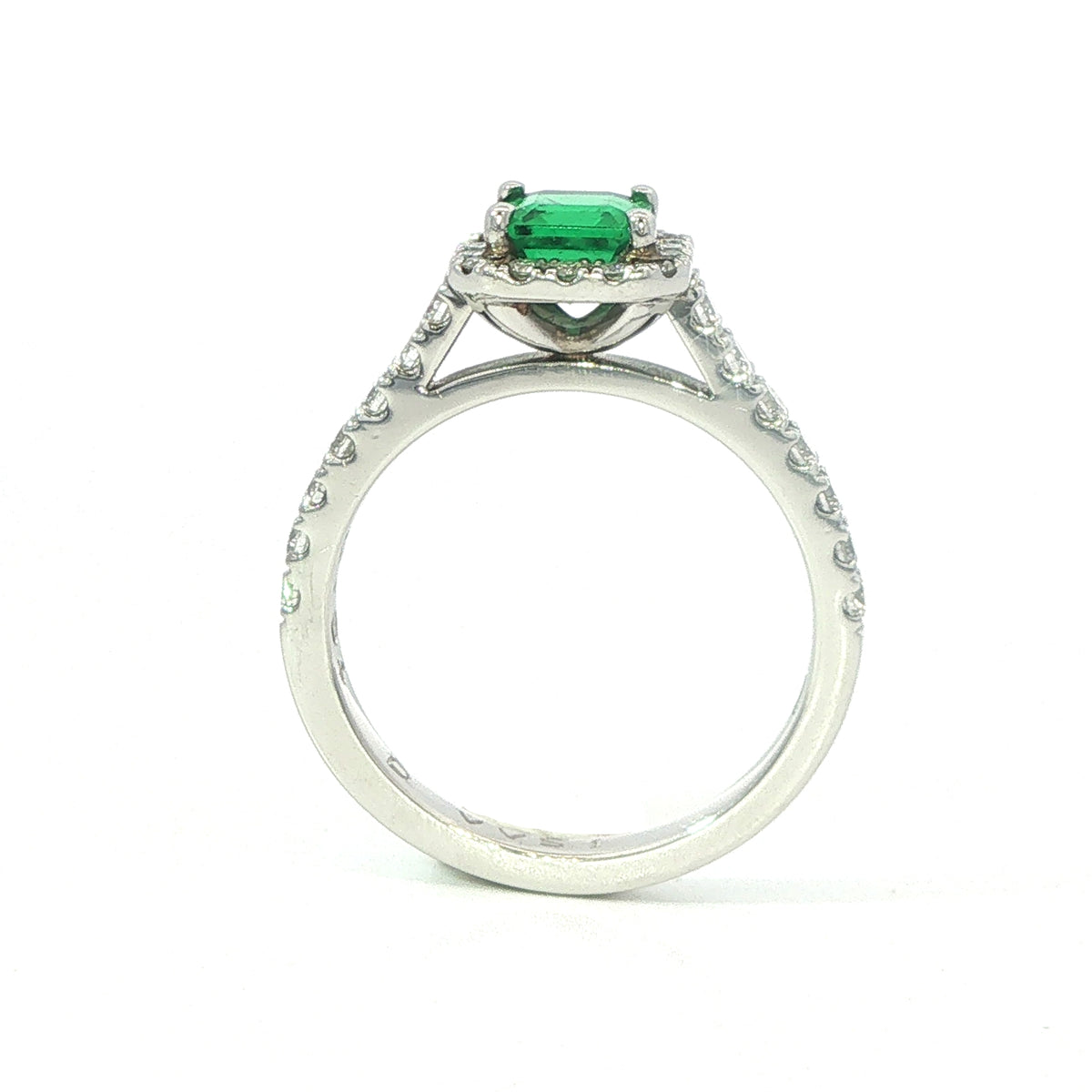 A Platinum Emerald and Diamond Halo Ring