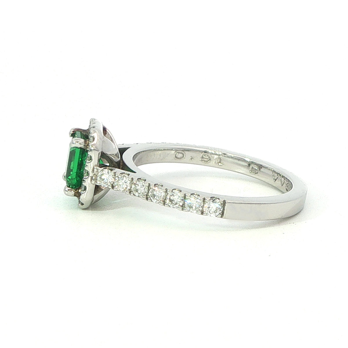A Platinum Emerald and Diamond Halo Ring