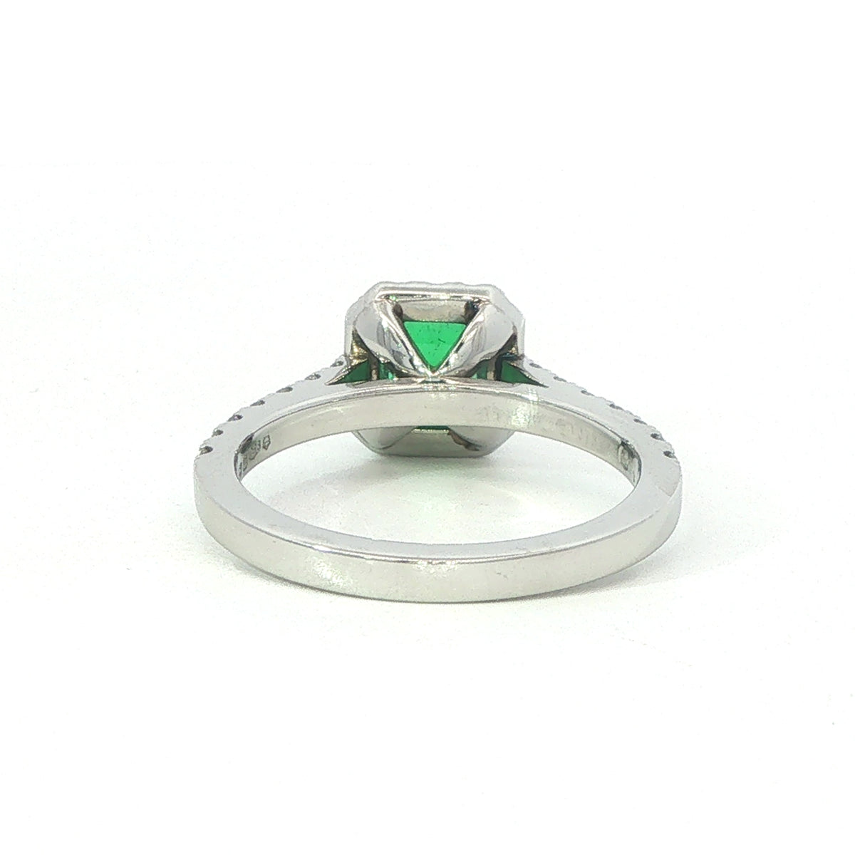 A Platinum Emerald and Diamond Halo Ring