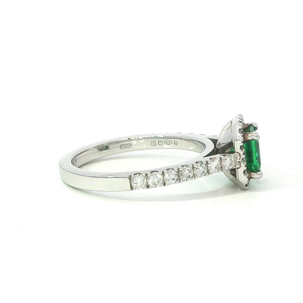 A Platinum Emerald and Diamond Halo Ring