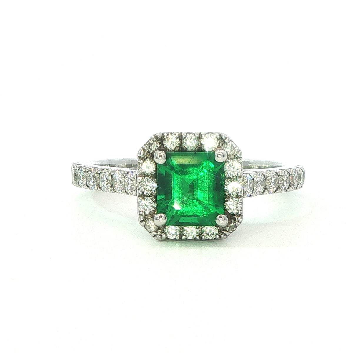 A Platinum Emerald and Diamond Halo Ring