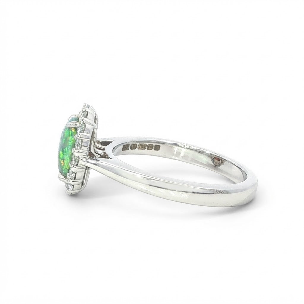 An 18 Carat White Gold Black Opal and Diamond Halo Ring