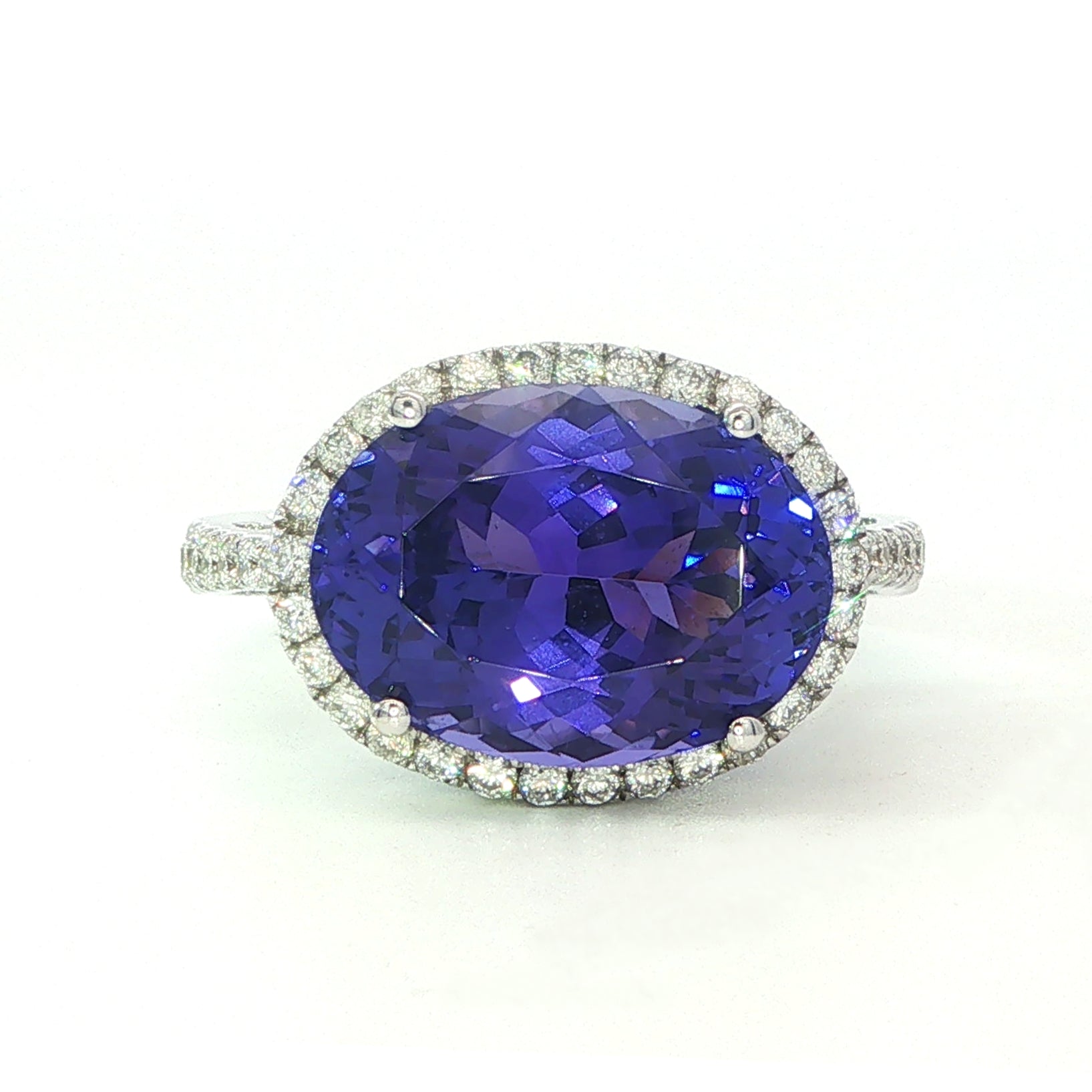 AN 18 Carat White Gold Tanzanite and Diamond Halo Cocktail Ring