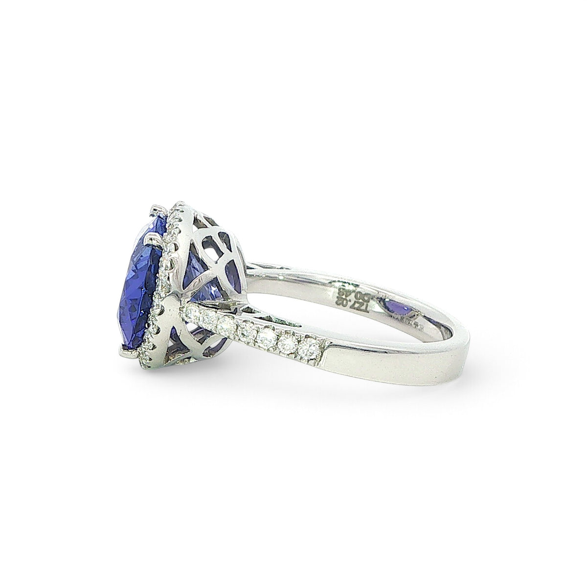 An 18 Carat White Gold Tanzanite and Diamond Halo Cocktail Ring