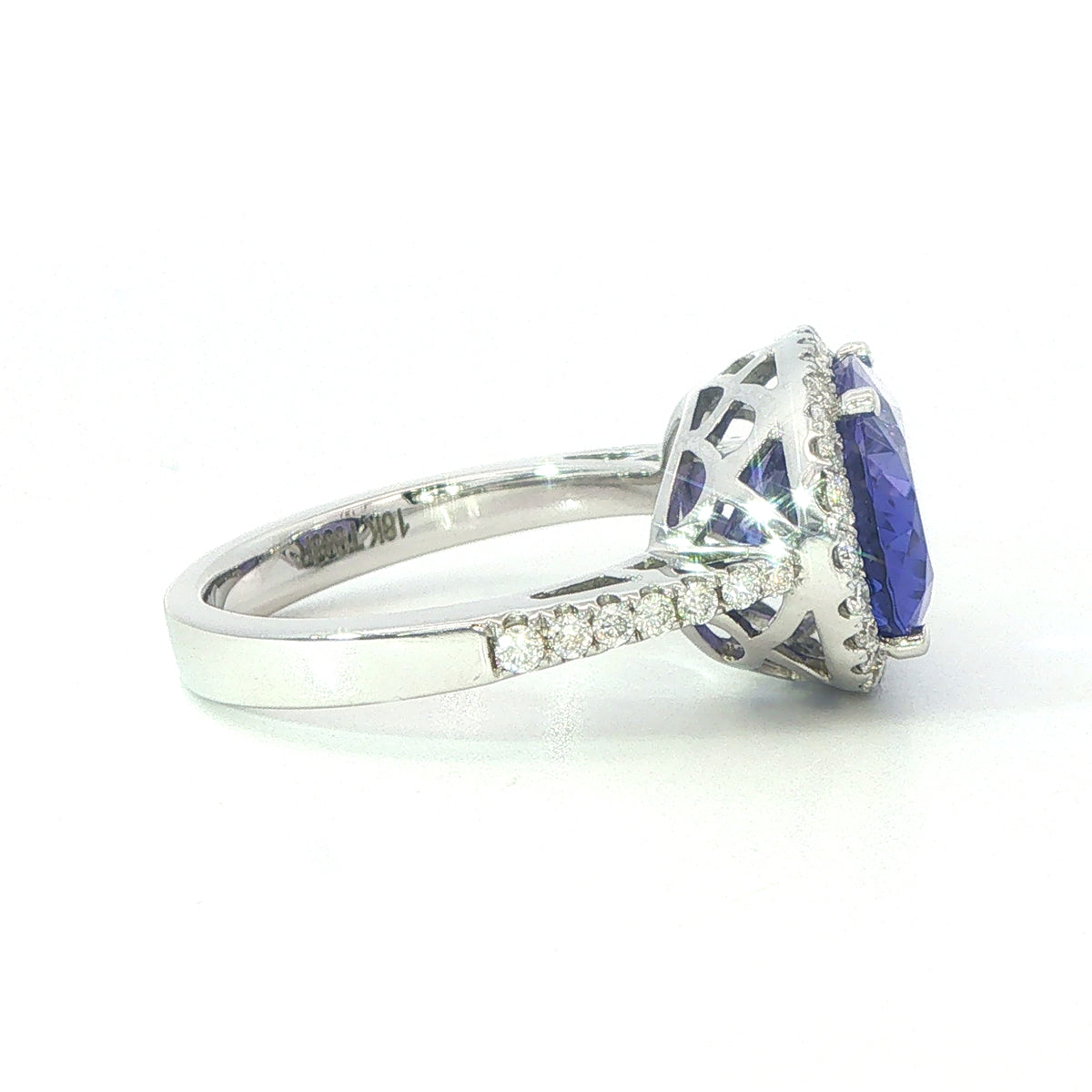 AN 18 Carat White Gold Tanzanite and Diamond Halo Cocktail Ring
