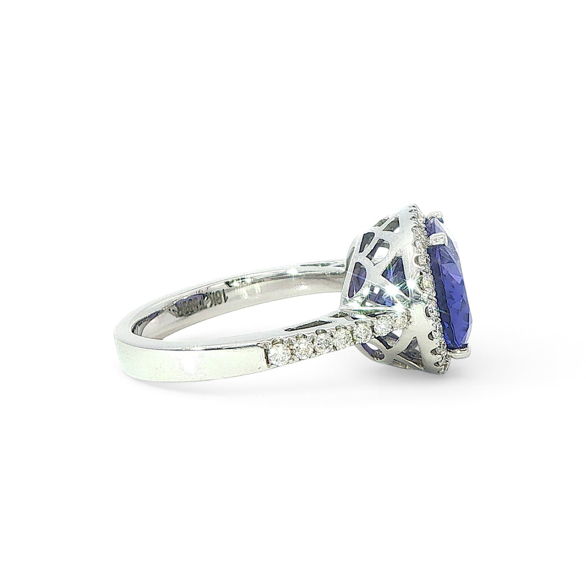 An 18 Carat White Gold Tanzanite and Diamond Halo Cocktail Ring