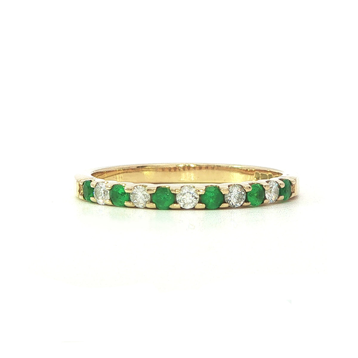 An 18 Carat Yellow Gold Emerald and Diamond Cog Set ½ Eternity Ring