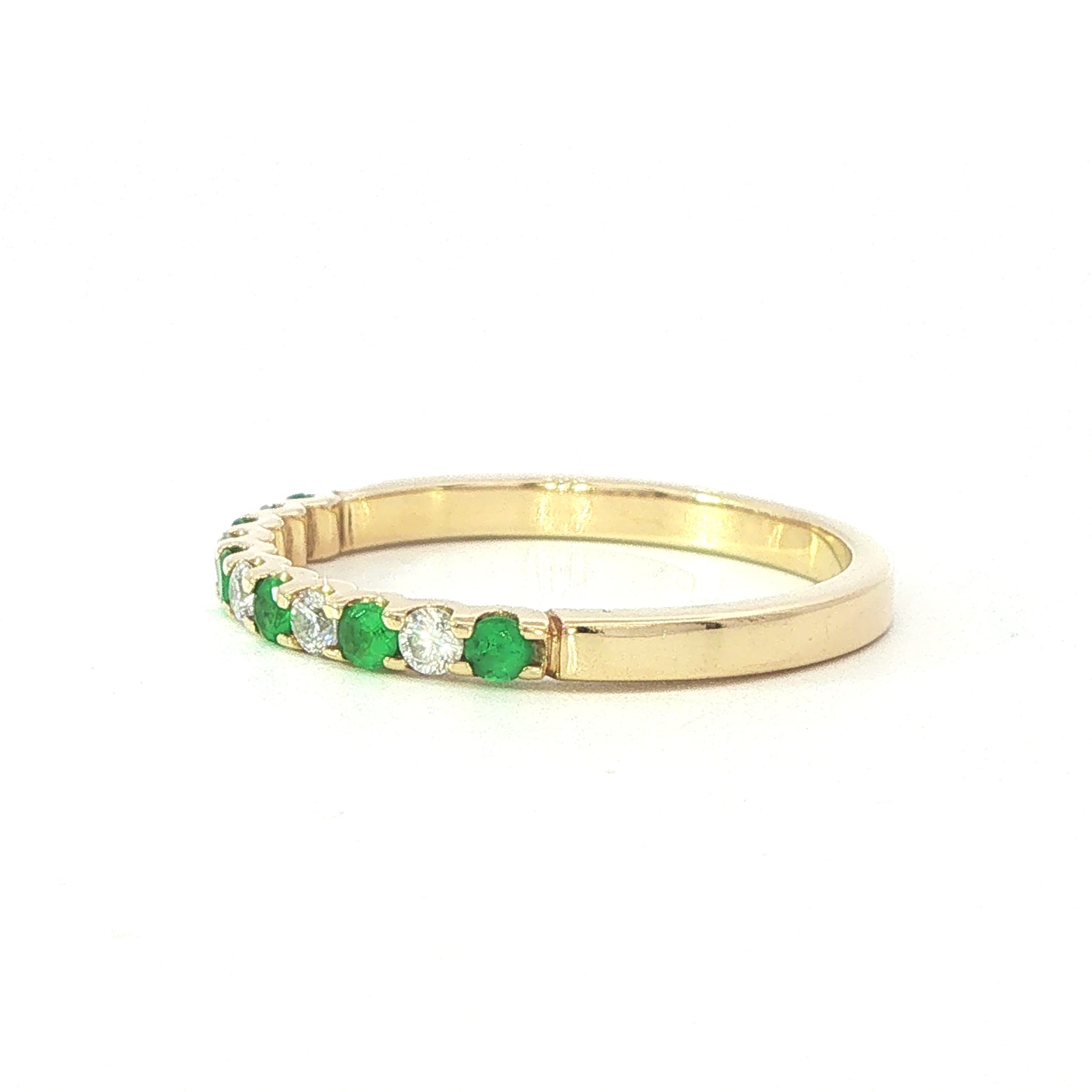 An 18 Carat Yellow Gold Emerald and Diamond Cog Set ½ Eternity Ring