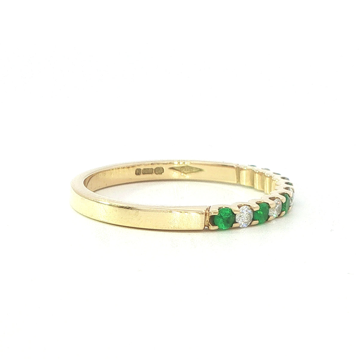 An 18 Carat Yellow Gold Emerald and Diamond Cog Set ½ Eternity Ring