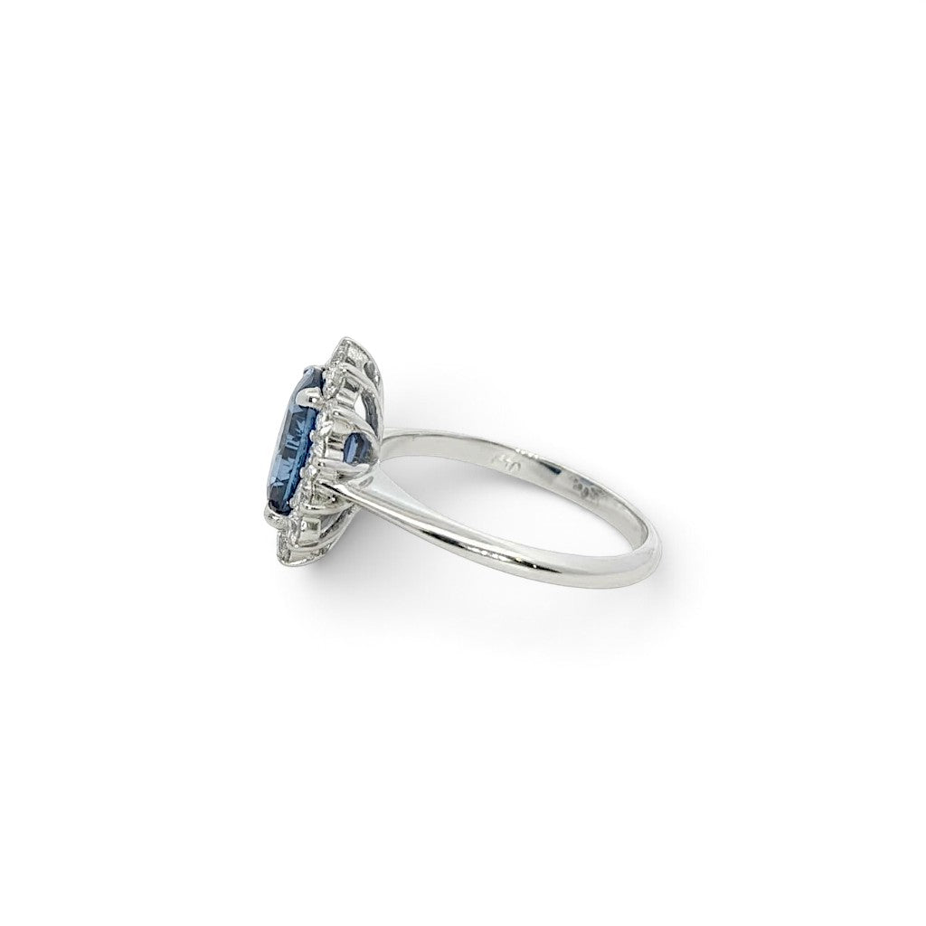 A modern 18 carat white gold Sapphire 2.64 Cts and diamond 0.42 Cts cluster ring.