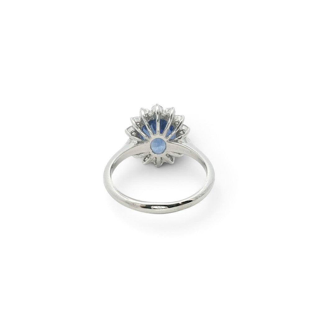 A modern 18 carat white gold Sapphire 2.64 Cts and diamond 0.42 Cts cluster ring.