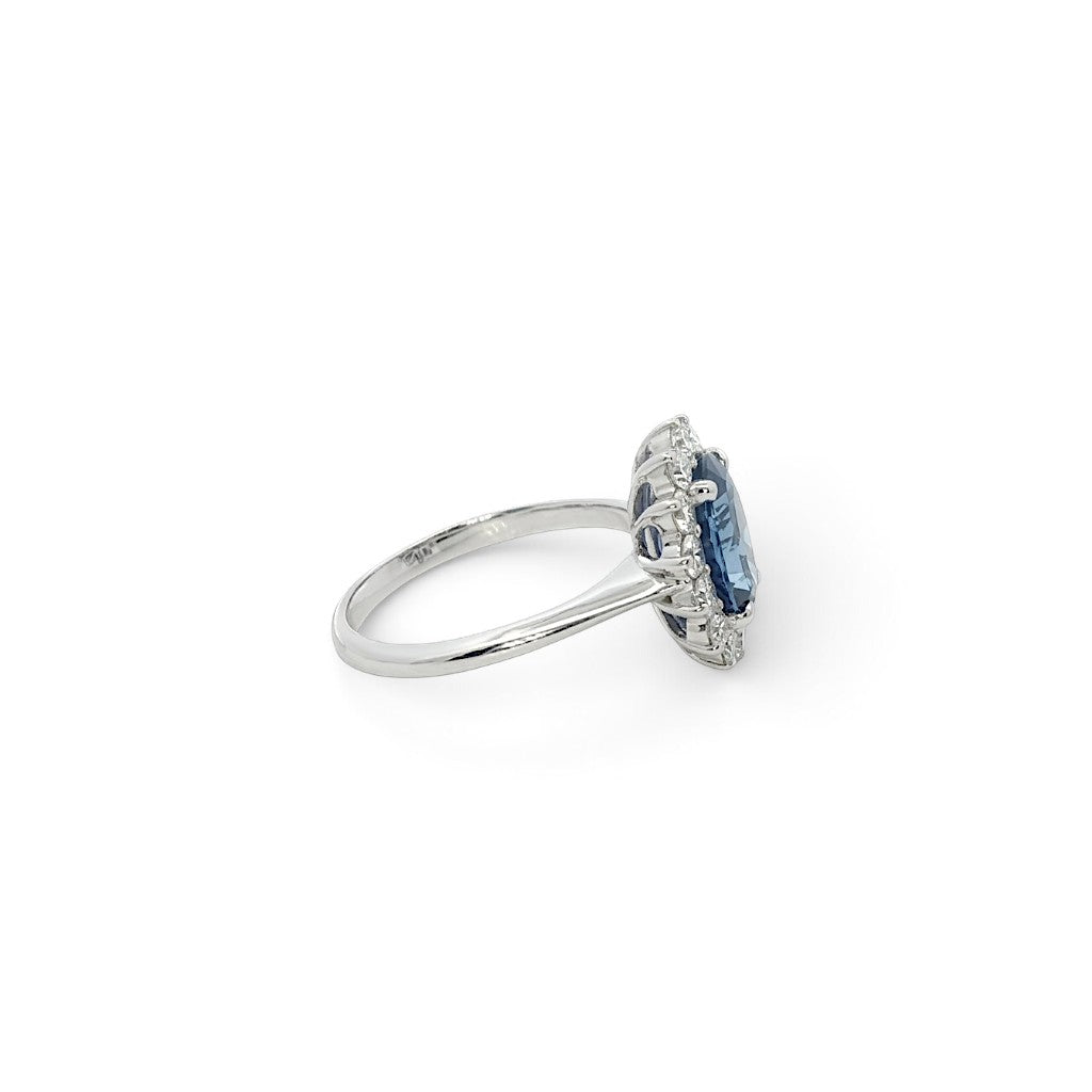 A modern 18 carat white gold Sapphire 2.64 Cts and diamond 0.42 Cts cluster ring.