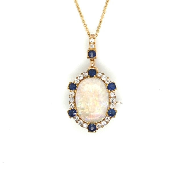 A yellow gold Opal pendant featuring Diamonds and Sapphire