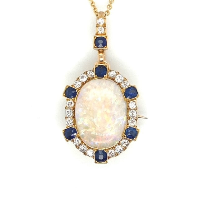 A yellow gold Opal pendant featuring Diamonds and Sapphire