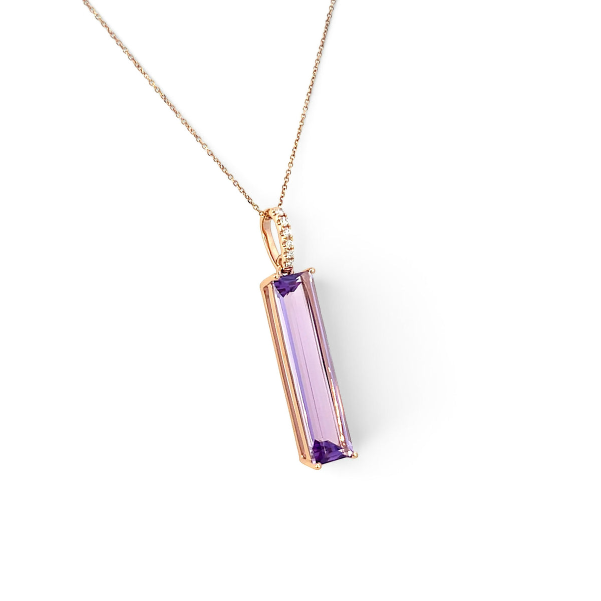  A modern 18 carat rose gold amethyst and diamond pendant. Featuring a 6x25mm step cut amethyst in a four claw double gallery setting to an articulated rose gold bail set with six (6) claw set natural modern round brilliant diamonds of G/H colour VS clarity. To a 46cm inch rose gold trace chain with an extender loop at 41cms