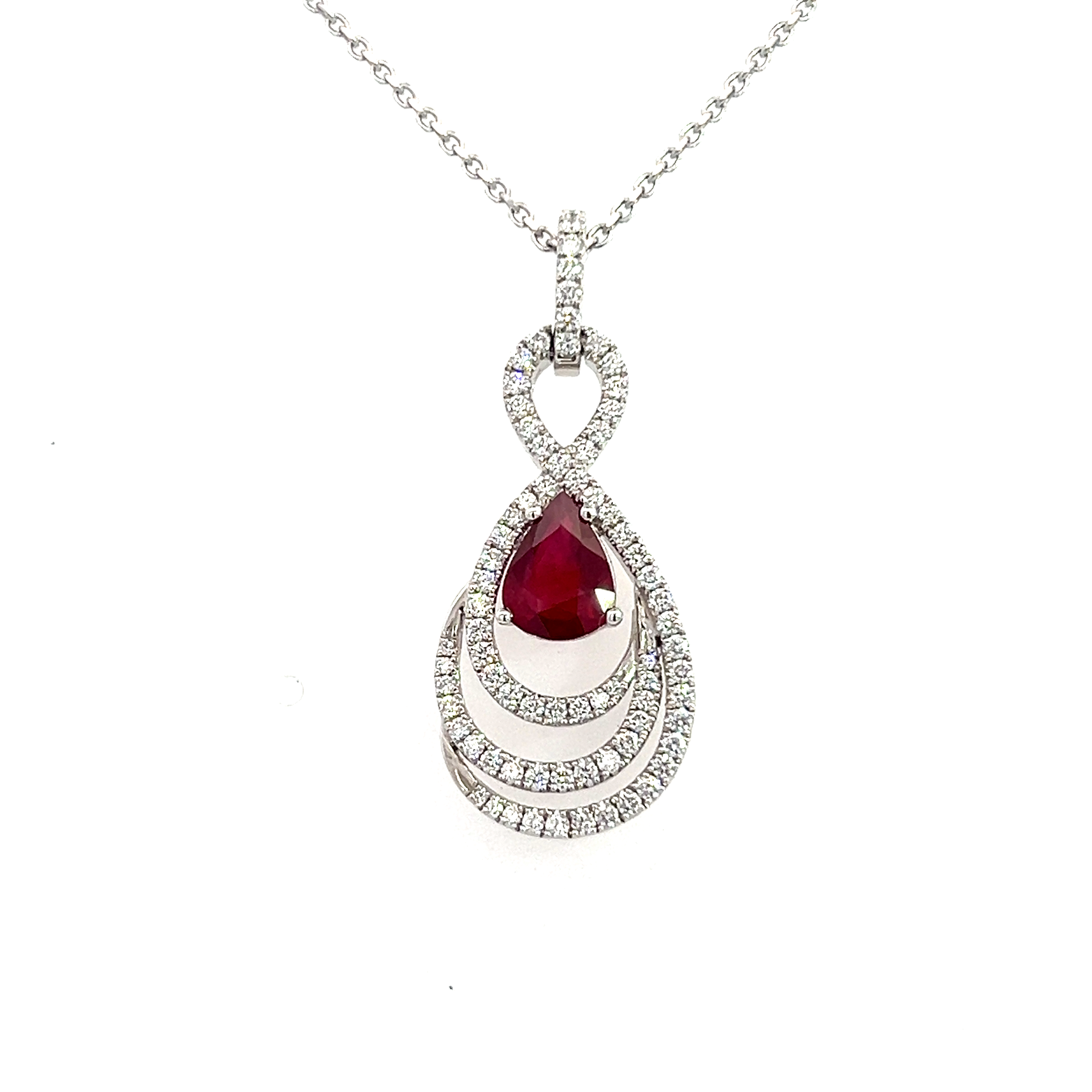 A 18 Carat White Gold, Ruby and Diamond Figure 8 Swirl Pendant