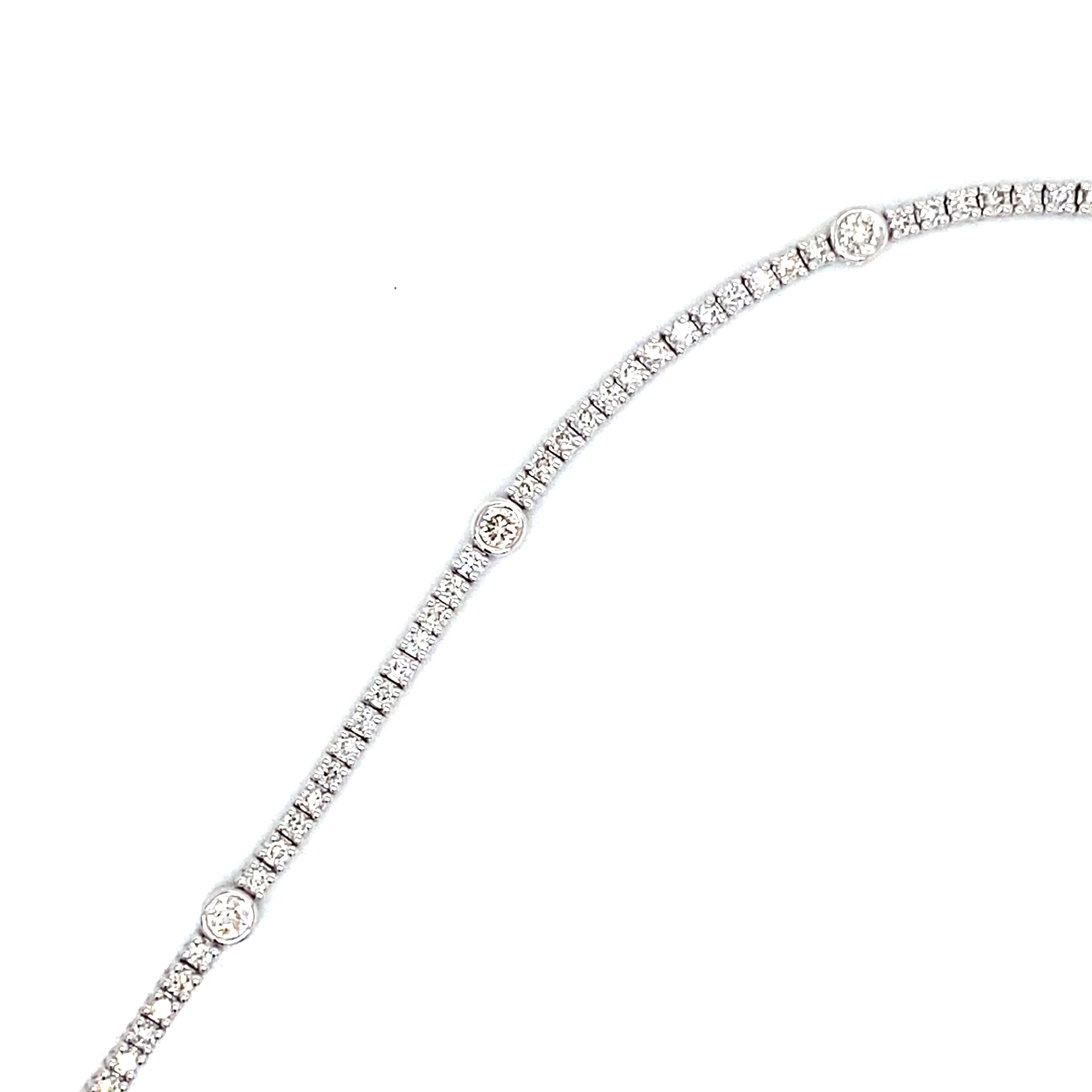 A Platinum and Diamond Line Bracelet with Diamond Spot Detail