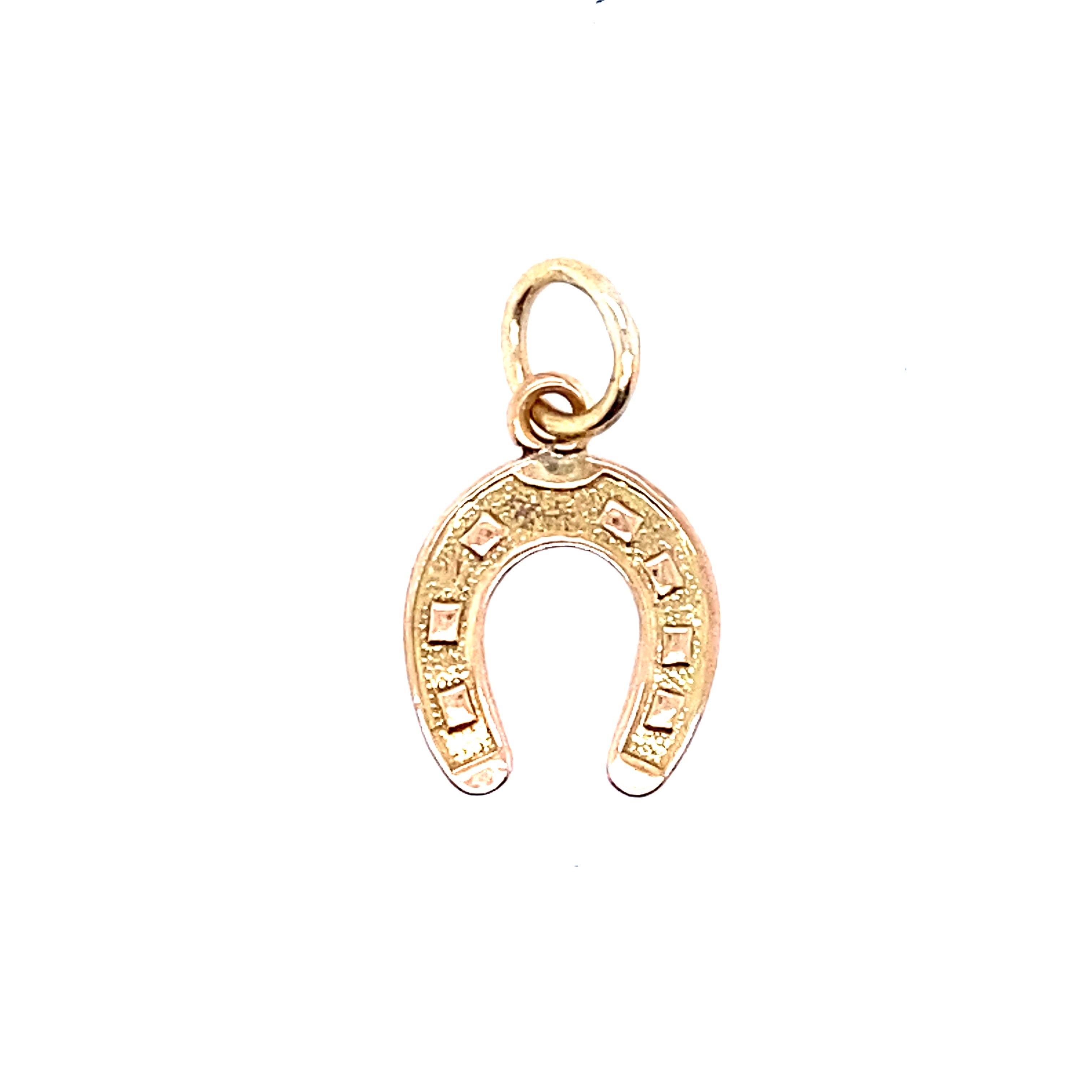 A horseshoe charm in yellow gold