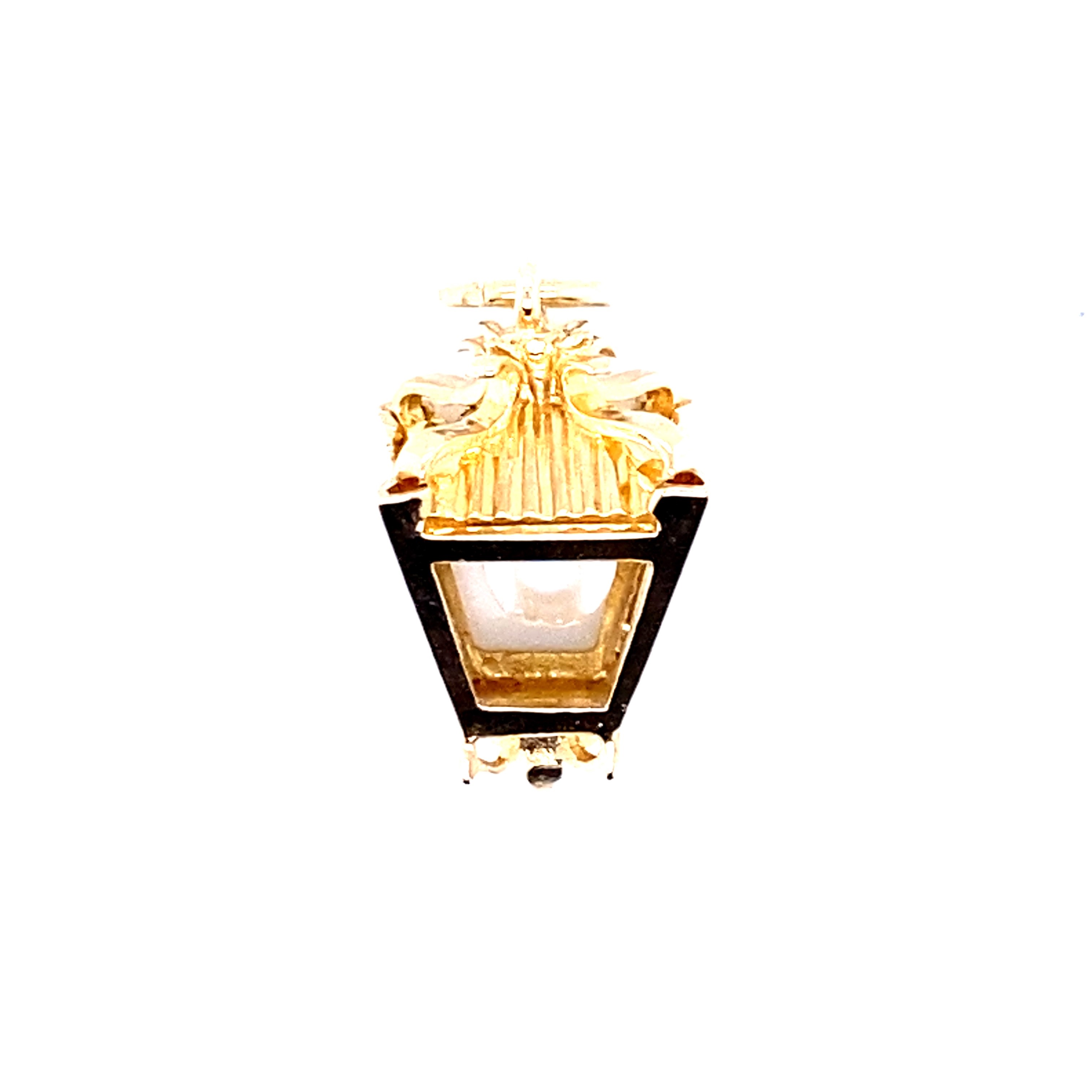 A yellow gold charm featuring a lantern